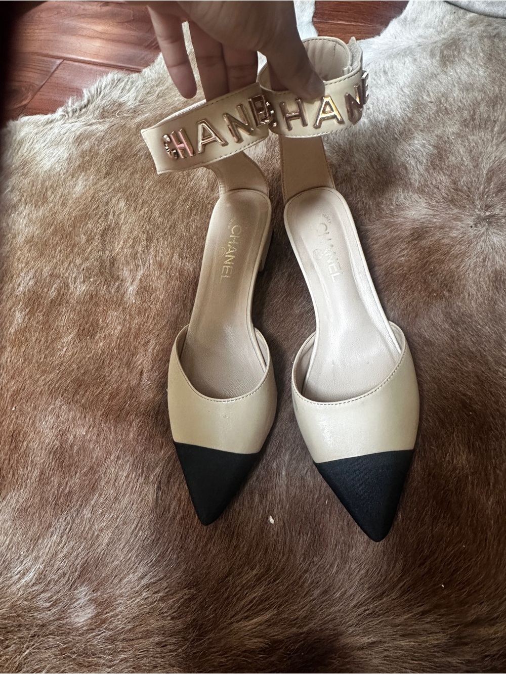 CHANEL Beige and Black Pointed-Toe Slingback Heels with Gold Logo Strap